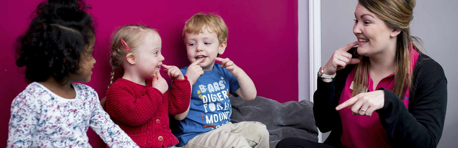 nursery practitioner with children